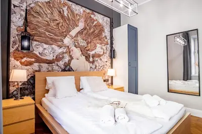 a bedroom with a bed with white towels on it at AT Krakow Apartments in Kraków