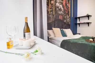 a room with a bottle of wine and a bed at AT Krakow Apartments in Kraków