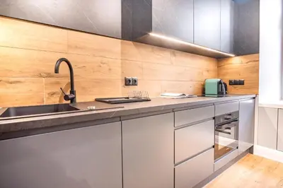 a kitchen with a sink and a counter top at AT Krakow Apartments in Kraków