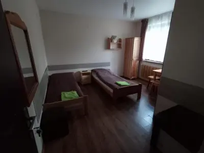 a small room with a bed and a window at Noclegi Pod Dębem in Skawina