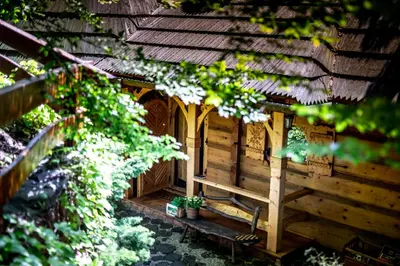 a wooden bird house in a garden at Przystań 545 in Rożnów