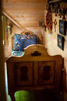 a bedroom with a bed in a wooden room at Przystań 545 in Rożnów