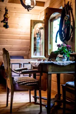 a room with a wooden table with flowers on it at Przystań 545 in Rożnów