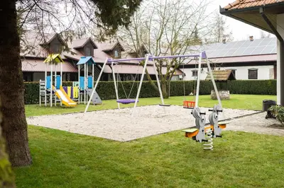 a park with a playground with a swing at Apartamenty w Dworku Cheval in Kraków