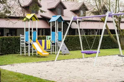 a group of playground equipment in a yard at Apartamenty w Dworku Cheval in Kraków