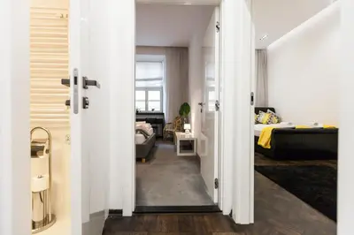 a room with a bed and a room with a door at Vintage Tomasza Apartment in Kraków