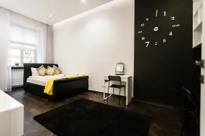a bedroom with a bed and a table and a desk at Vintage Tomasza Apartment in Kraków