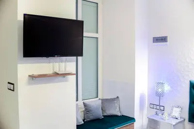 a living room with a couch and a flat screen tv at Apartment Jacuzzi in Kraków