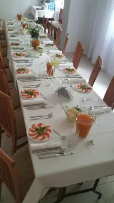 a long table with plates of food on it at Arka Kraków in Kraków