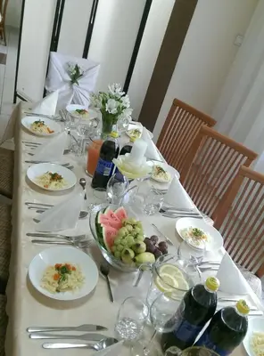 a table with plates of food on it with flowers at Arka Kraków in Kraków