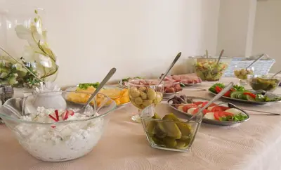 a table with many bowls of food on it at Arka Kraków in Kraków