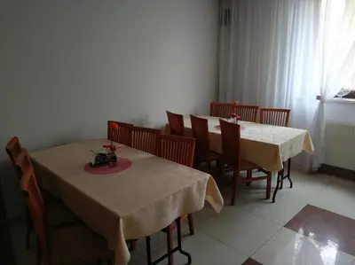 a dining room with two tables and chairs at Arka Kraków in Kraków