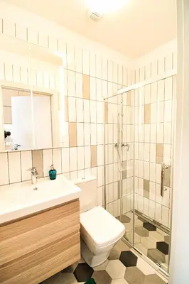a bathroom with a toilet and a sink and a shower at City Life Apartments Kraków in Kraków
