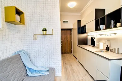 a small kitchen with a sink and a counter at City Life Apartments Kraków in Kraków