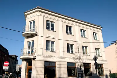 a large white building on a city street at City Life Apartments Kraków in Kraków