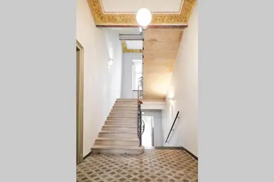 a staircase in a building with wooden ceilings at HOUSEHOST Apartment I: Studencka Street in Kraków