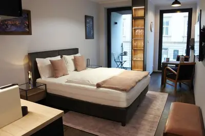 a bedroom with a bed and a desk in a room at BOUTIQUE 109 - old city, luxury apt. with a garage in Kraków