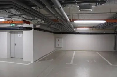 an empty parking garage with a large room with white walls at BOUTIQUE 109 - old city, luxury apt. with a garage in Kraków