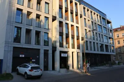 a white car parked in front of a building at BOUTIQUE 109 - old city, luxury apt. with a garage in Kraków