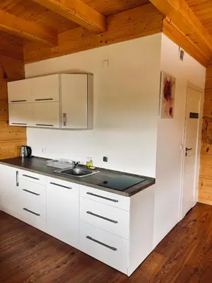 a kitchen with white cabinets and a sink at Domki góralskie na Podhalu Zakopane in Tokarnia