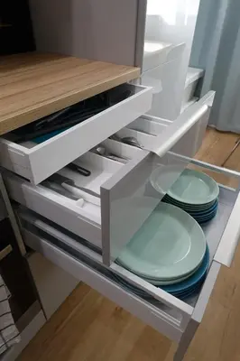 a drawer with plates inside of a refrigerator at Three Rooms Apartment in Kraków