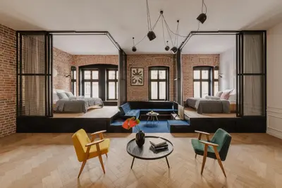 a living room with a couch and a table at LaRry BirD Old Town by WillyWalls in Kraków