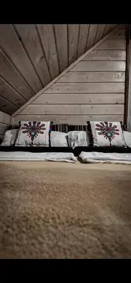 two beds with pillows sitting in a room at Domki na Zagroniu in Koninki