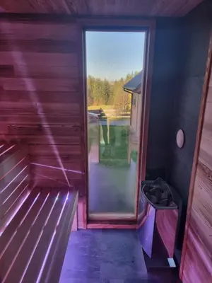 a view from the inside of a tiny house with a window at Domki na Zagroniu in Koninki
