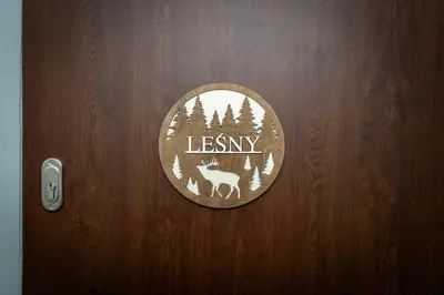 a wooden door with a sign that says lesney at Przystanek Leśna-3 Apartamenty nad potokiem w sercu natury in Targanice
