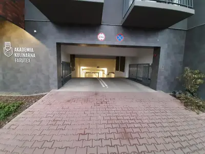 an empty parking lot in front of a building at Jack II Apartment in Kraków