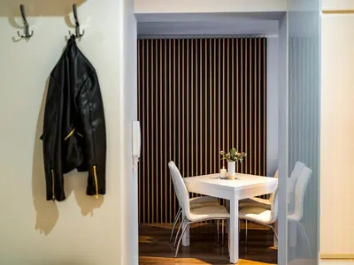 a dining room with a white table and chairs at Jack II Apartment in Kraków