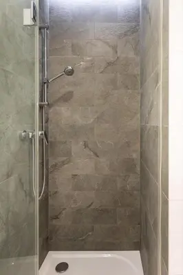 a bathroom with a shower with a glass door at Jack II Apartment in Kraków