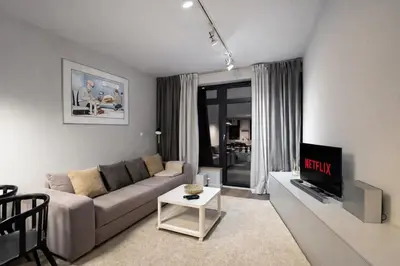 a living room with a couch and a tv at InPoint Executive Apartments near Old Town & Kazimierz District in Kraków