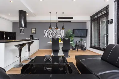 a living room with a couch and a tv at InPoint Executive Apartments near Old Town & Kazimierz District in Kraków