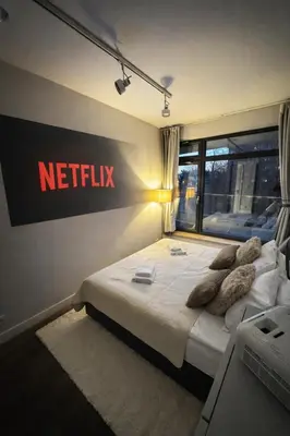 a bedroom with a large bed with brown pillows at InPoint Executive Apartments near Old Town & Kazimierz District in Kraków