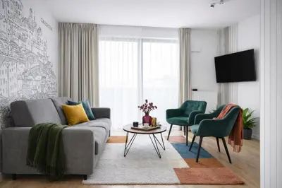 a living room with a couch and two chairs at InPoint Executive Apartments near Old Town & Kazimierz District in Kraków
