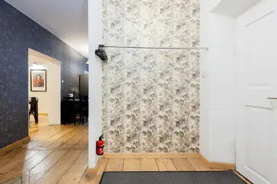 a room with a shower with a wall at Prime Location Apartment in Kraków