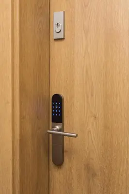 a door with a cell phone sticking out of it at City of the Kings - Smile Apartment in Kraków