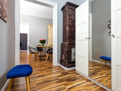 a hallway with a mirror and a dining room with a table at CracWoW Old Town Apartment in Kraków
