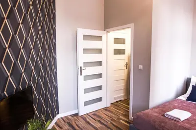 a room with a door open to a bedroom at CracWoW Old Town Apartment in Kraków