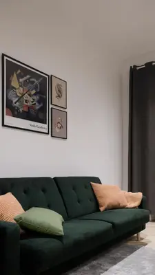 a green couch sitting in a living room at Apartament LIMANO in Kraków