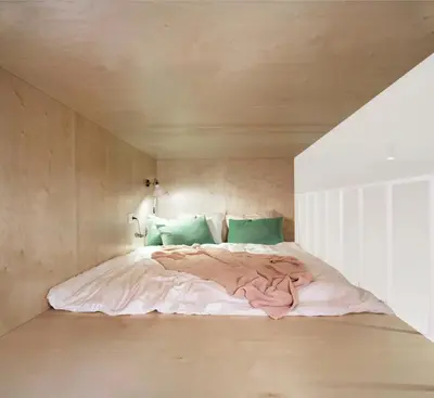 a bedroom with a bed with green pillows at Apartament LIMANO in Kraków