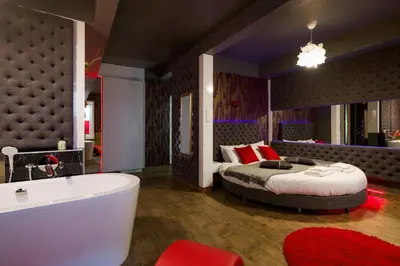 a bedroom with a bed and a bath tub at Yourplace Romantic Apartment with private patio in Kraków