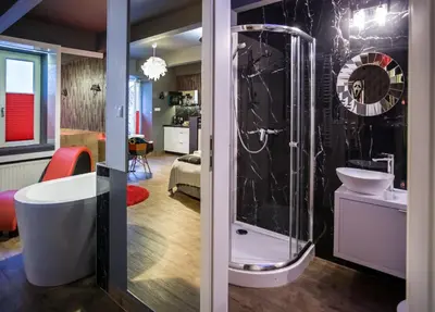 a bathroom with a shower and a bath tub at Yourplace Romantic Apartment with private patio in Kraków