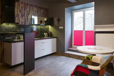 a kitchen with a table and a table and a window at Yourplace Romantic Apartment with private patio in Kraków