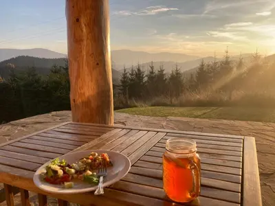 a plate of food on a table with a drink at Osada Beskidzka in Zawoja