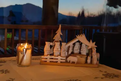 a wooden model of a house on a table with a candle at Osada Beskidzka in Zawoja