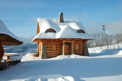 a log cabin with snow on the roof at Osada Beskidzka in Zawoja