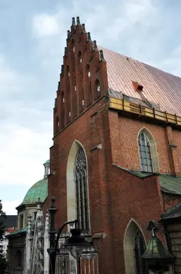 a large brick building with a tower on top of it at Hotel Santi in Kraków