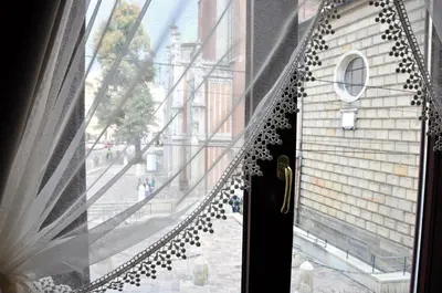 a window with a door with a view of a street at Hotel Santi in Kraków